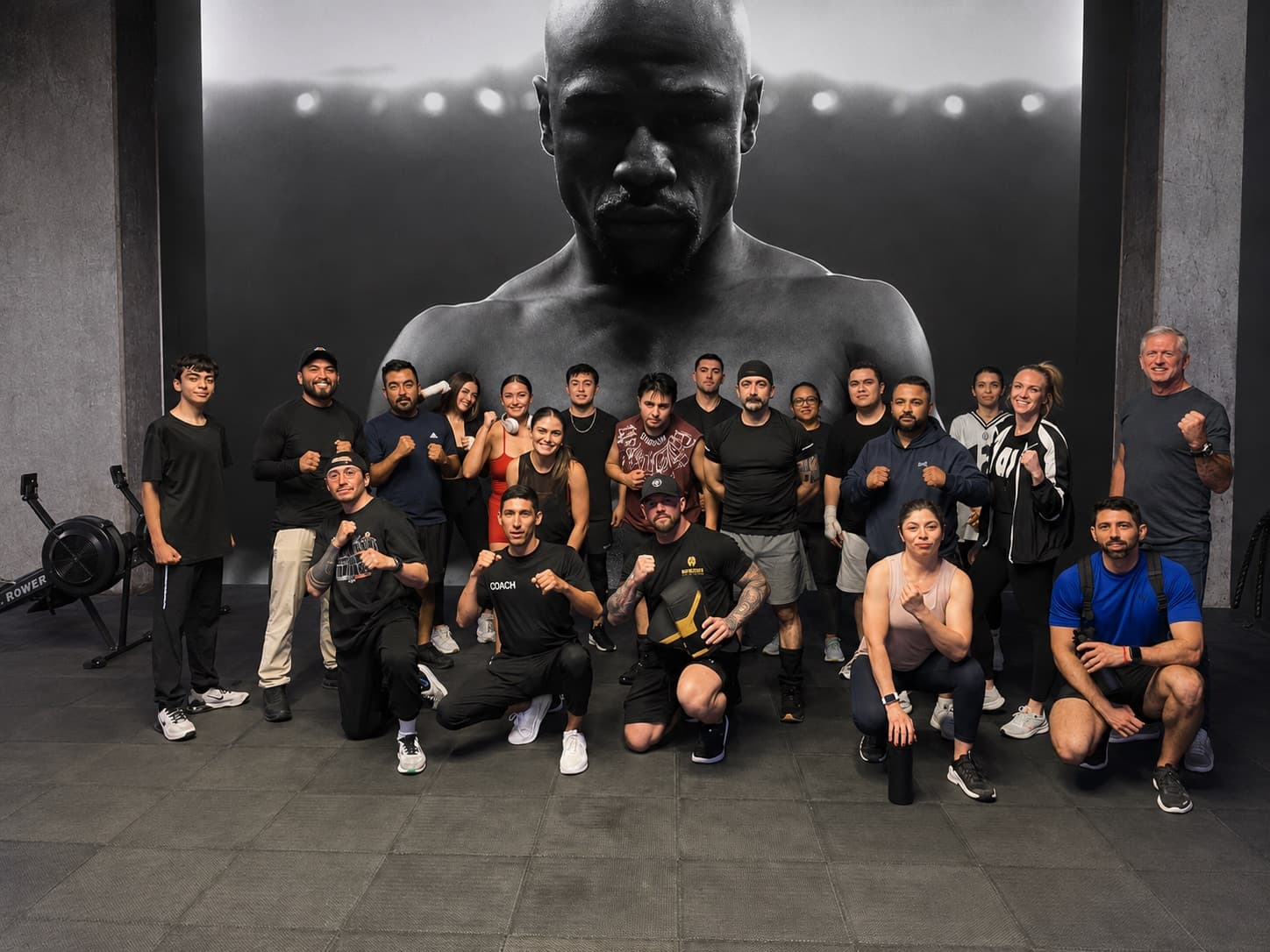 Members and coaches at Mayweather Boxing + Fitness posing together on the gym floor